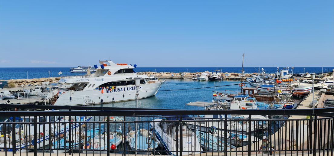 harbour with a yacht and fishing boats on the Cypriot coast