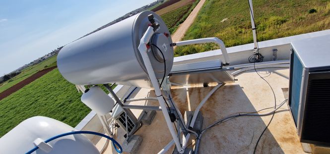 water tank and solar water heater on the roof of a Cypriot house