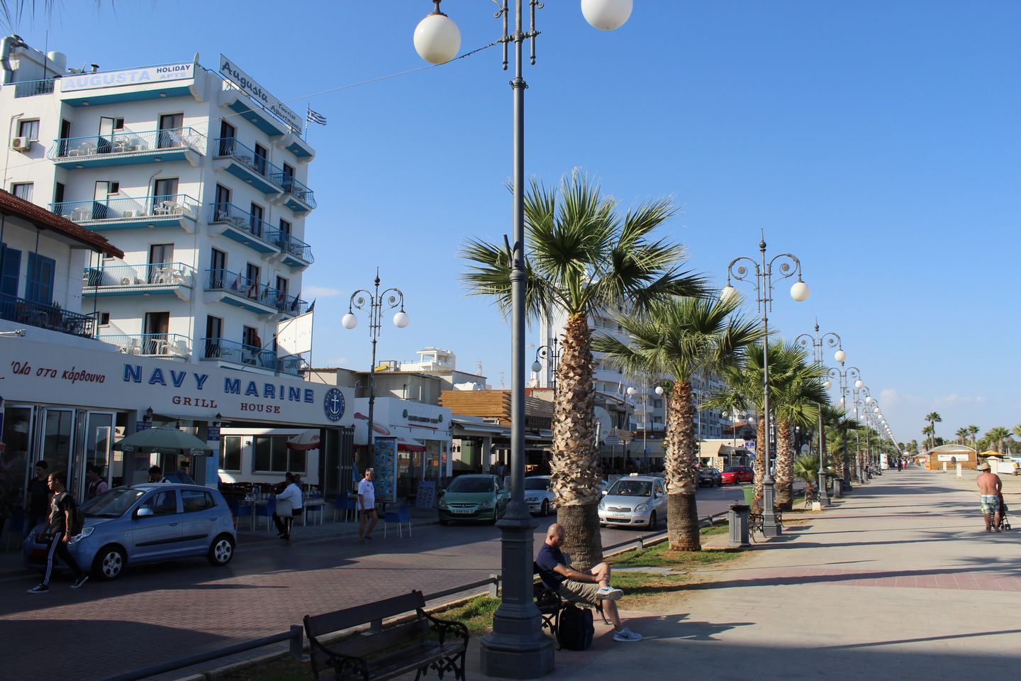 promenade with palm trees and restaurants along the Finikoudes waterfront in Larnaca