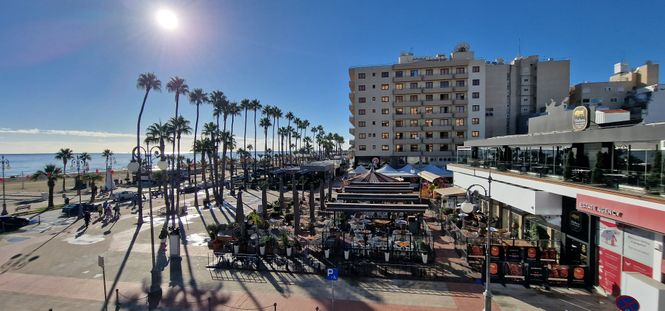 Finikoudes promenade in Larnaca with palm trees, restaurants, and sea view