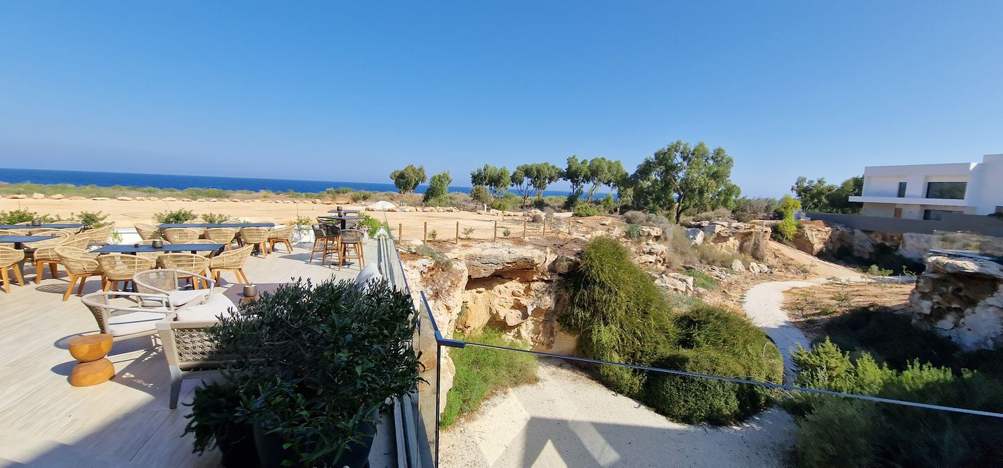 restaurant terrace overlooking the sea with rock grottos in Paralimni